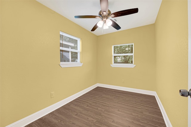 2406 W Elvinta St, Baytown, TX 77520 - unfurnished room with healthy amount of natural light, dark wood-style flooring, and baseboards