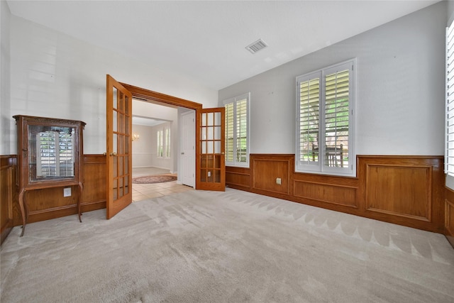 14414 Spanish River Ln, Cypress, TX 77429 - tiled spare room with wainscoting, french doors, carpet floors, and wood walls