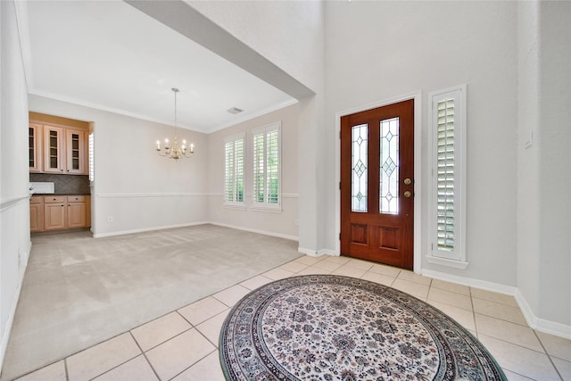 14414 Spanish River Ln, Cypress, TX 77429 - entrance foyer featuring a chandelier, light tile patterned flooring, light colored carpet, baseboards, and crown molding