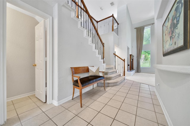 14414 Spanish River Ln, Cypress, TX 77429 - entryway featuring stairs, light tile patterned floors, a towering ceiling, and baseboards