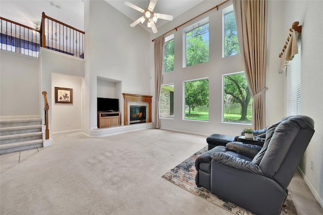 14414 Spanish River Ln, Cypress, TX 77429 - carpeted living area with a high ceiling, built in features, ceiling fan, baseboards, and stairs