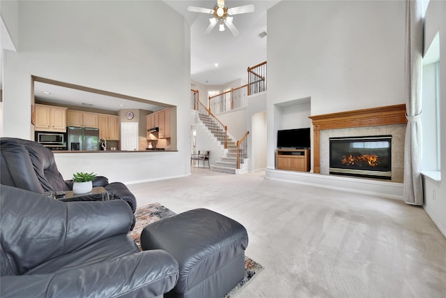 14414 Spanish River Ln, Cypress, TX 77429 - living room with a high ceiling, built in features, a ceiling fan, light carpet, and stairs