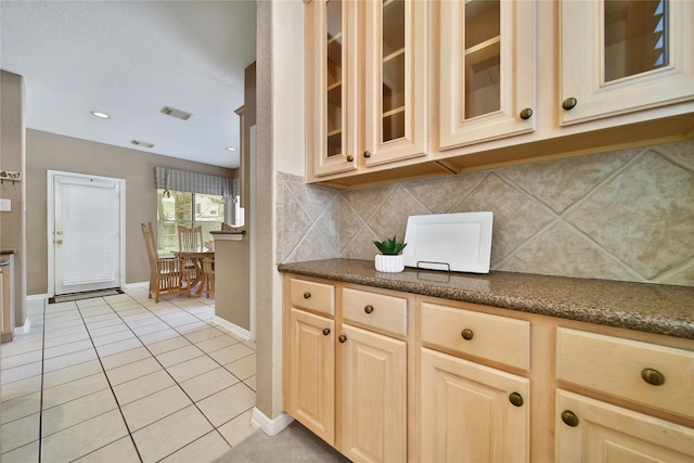 14414 Spanish River Ln, Cypress, TX 77429 - kitchen featuring light tile patterned flooring, baseboards, glass insert cabinets, backsplash, and light brown cabinetry