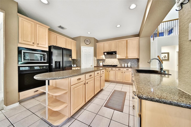 14414 Spanish River Ln, Cypress, TX 77429 - kitchen featuring black oven, light brown cabinetry, stainless steel microwave, a sink, and open shelves