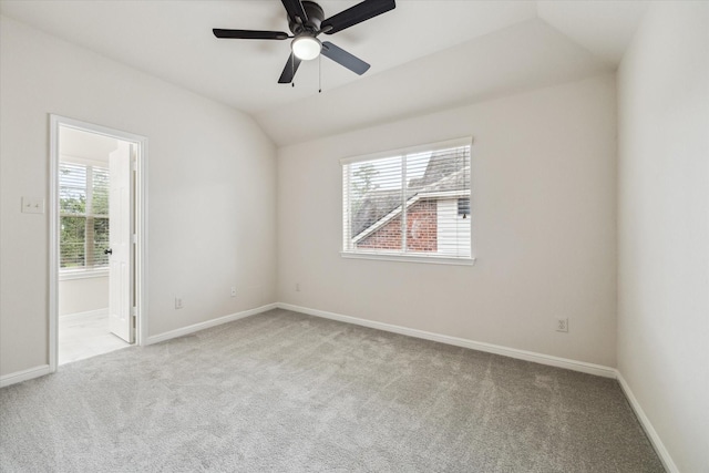 13411 SE Via Chianti Ln, Cypress, TX 77429 - spare room featuring carpet flooring, plenty of natural light, vaulted ceiling, and baseboards