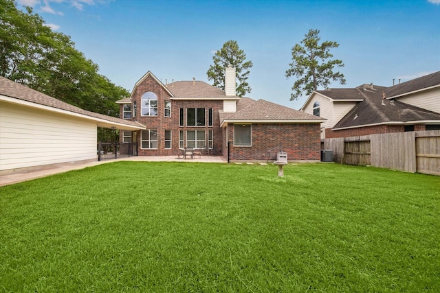 13411 SE Via Chianti Ln, Cypress, TX 77429 - back of house featuring a patio area, brick siding, a chimney, a shingled roof, and central AC unit
