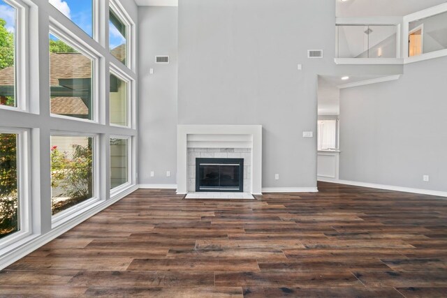 1806 Quiet Country Ct, Houston, TX 77345 - unfurnished living room featuring a high ceiling, baseboards, and dark wood finished floors
