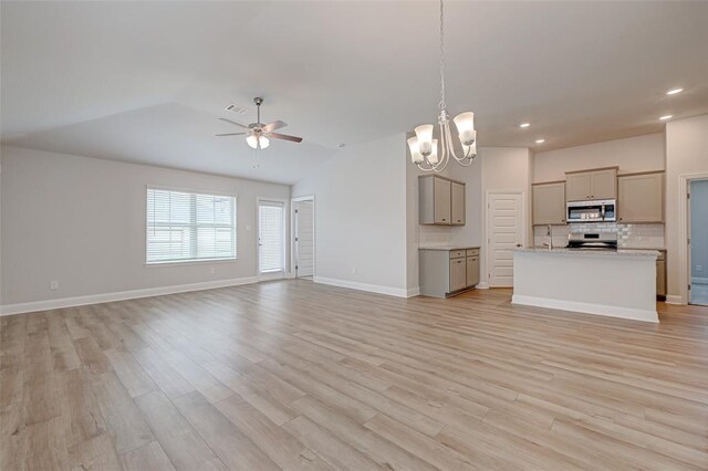 2214 Salton Sea Ln, Texas City, TX 77568 - unfurnished living room featuring a chandelier, a ceiling fan, light wood-type flooring, recessed lighting, and vaulted ceiling