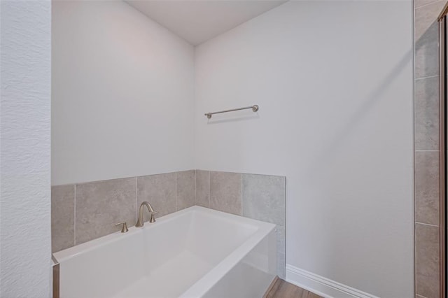 2214 Salton Sea Ln, Texas City, TX 77568 - full bath featuring a bath, wood finished floors, and baseboards