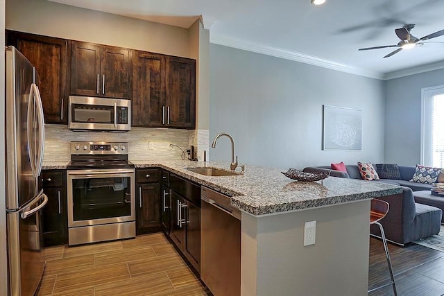 2400 Mccue Rd Unit 250, Houston, TX 77056 - kitchen featuring appliances with stainless steel finishes, a sink, open floor plan, a ceiling fan, and backsplash