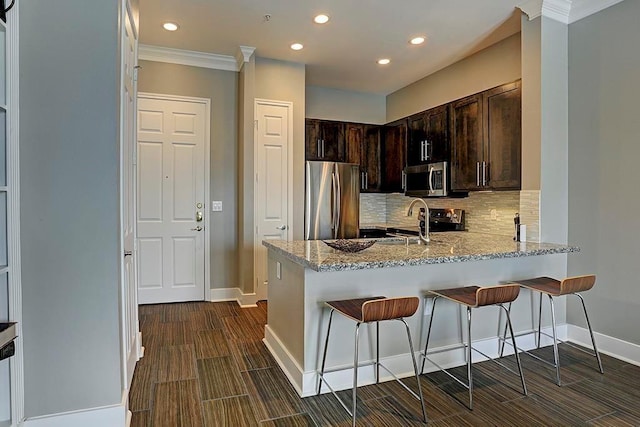2400 Mccue Rd Unit 250, Houston, TX 77056 - kitchen featuring stainless steel appliances, recessed lighting, backsplash, baseboards, and light stone countertops