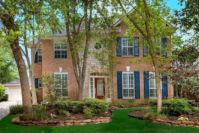 14 Heaven Tree, The Woodlands, TX 77382 - view of front of property with brick siding, a garage, and a front lawn
