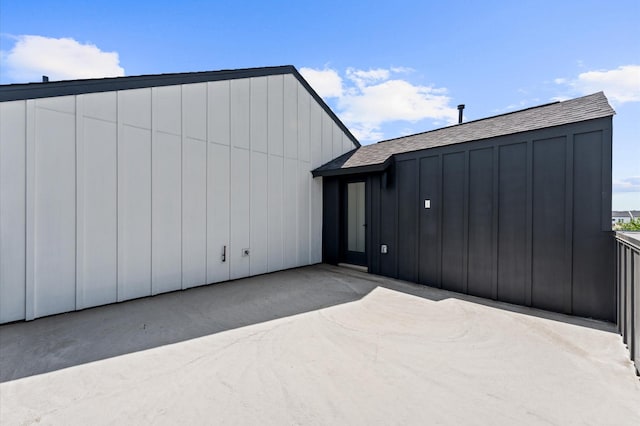3209 Baer St Unit B, Houston, TX 77020 - back of house featuring board and batten siding, a shingled roof, and a patio