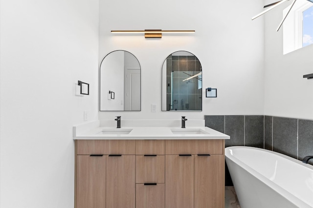 3209 Baer St Unit B, Houston, TX 77020 - bathroom featuring double vanity, a freestanding bath, a stall shower, and marble finish floors