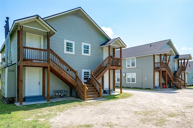 214 W Republic St Unit 10, Baytown, TX 77520 - rear view of property featuring stairway and driveway