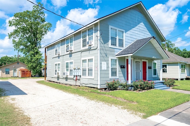 214 W Republic St Unit 10, Baytown, TX 77520 - view of front of property featuring a porch, driveway, and a front lawn