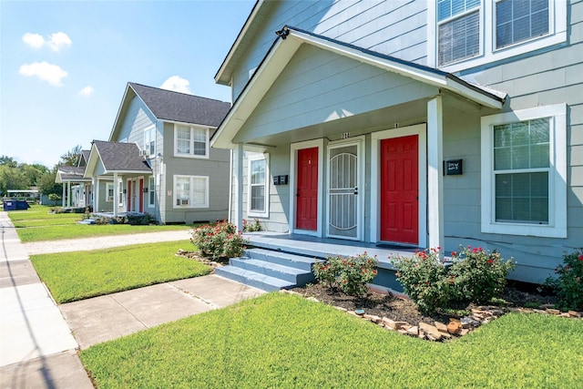 214 W Republic St Unit 10, Baytown, TX 77520 - view of front of home featuring a front yard and a porch