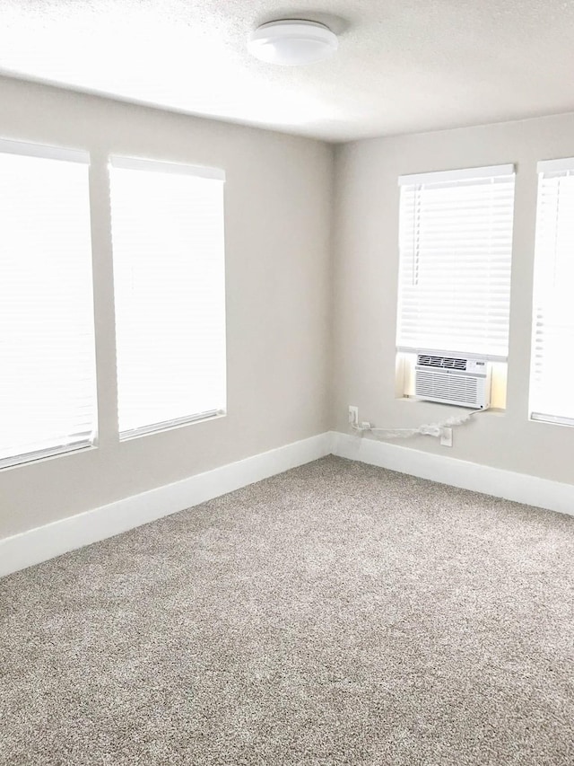 214 W Republic St Unit 10, Baytown, TX 77520 - carpeted empty room featuring baseboards and cooling unit