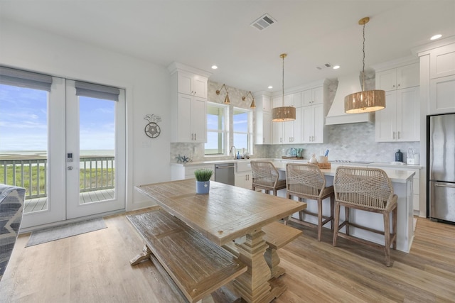 3903 Evening Primrose Dr, Galveston, TX 77554 - dining area featuring light wood-type flooring, recessed lighting, and french doors