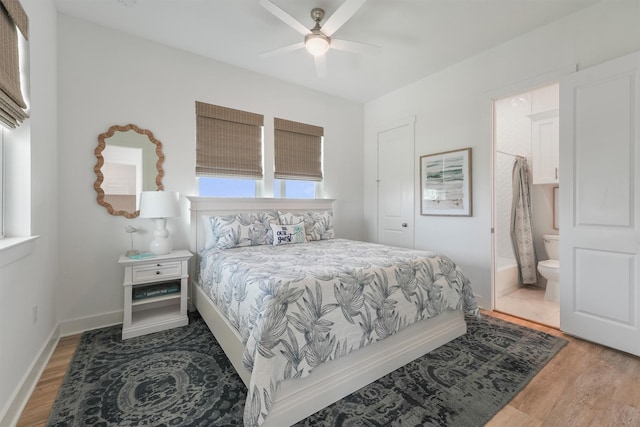3903 Evening Primrose Dr, Galveston, TX 77554 - bedroom featuring wood finished floors, connected bathroom, baseboards, and a ceiling fan