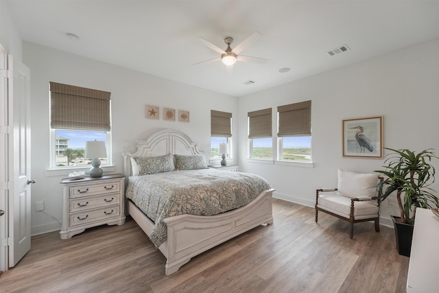 3903 Evening Primrose Dr, Galveston, TX 77554 - bedroom featuring light wood-type flooring, baseboards, and a ceiling fan