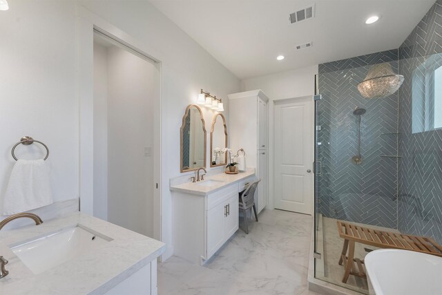 3903 Evening Primrose Dr, Galveston, TX 77554 - full bathroom with two vanities, marble finish flooring, a shower stall, a freestanding bath, and recessed lighting