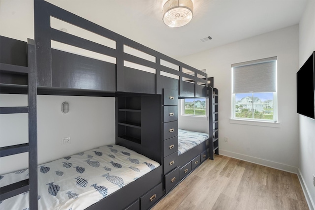 3903 Evening Primrose Dr, Galveston, TX 77554 - bedroom featuring light wood-style floors and baseboards