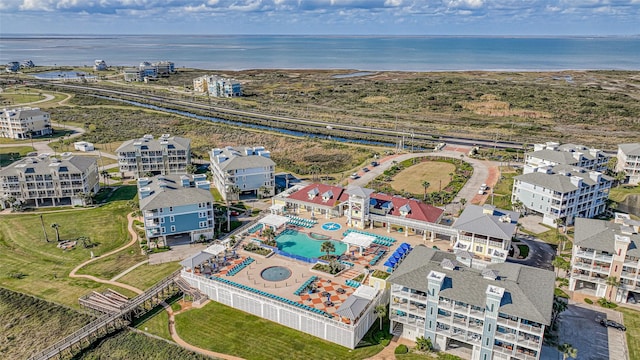 3903 Evening Primrose Dr, Galveston, TX 77554 - drone / aerial view of a pool area and a nearby body of water