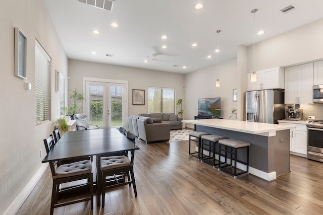 1703 Freeman St, Houston, TX 77009 - dining room featuring recessed lighting, french doors, dark wood-style flooring, and baseboards