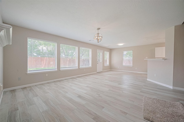 16502 N Glade Dr, Houston, TX 77073 - unfurnished room featuring a chandelier, light wood-style flooring, and baseboards