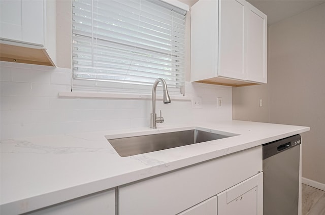 16502 N Glade Dr, Houston, TX 77073 - kitchen with dishwasher, a sink, decorative backsplash, white cabinetry, and light stone counters