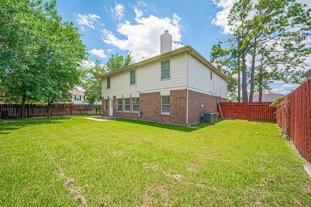16502 N Glade Dr, Houston, TX 77073 - back of house featuring central AC unit, brick siding, and a chimney