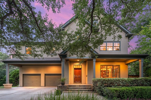 3502 Underwood St, Houston, TX 77025 - view of front of house with stucco siding, concrete driveway, an attached garage, and covered porch