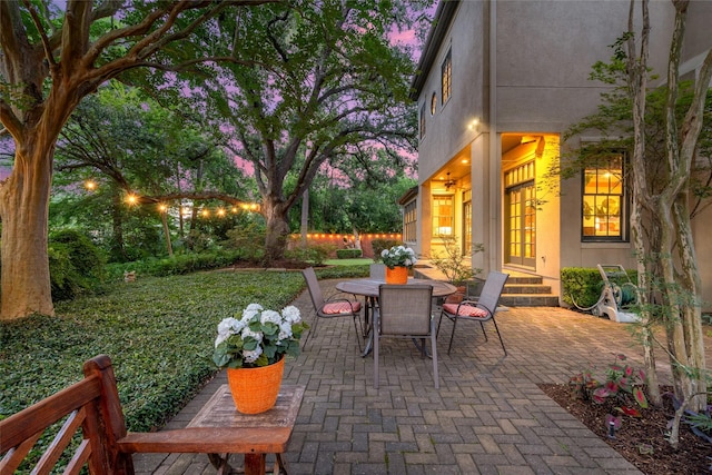 3502 Underwood St, Houston, TX 77025 - patio terrace at dusk featuring a patio area, outdoor dining area, and entry steps