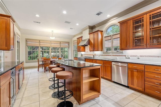 3502 Underwood St, Houston, TX 77025 - kitchen featuring stainless steel dishwasher, dark stone counters, light tile patterned floors, recessed lighting, and ornamental molding