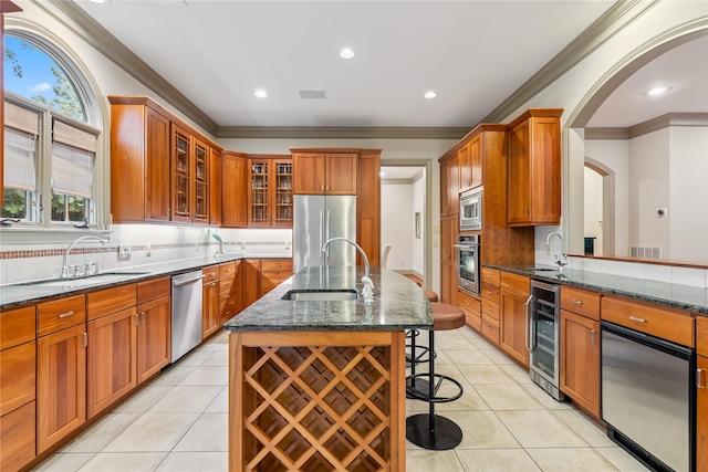 3502 Underwood St, Houston, TX 77025 - kitchen with beverage cooler, stainless steel appliances, crown molding, dark stone countertops, and a breakfast bar