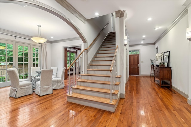 3502 Underwood St, Houston, TX 77025 - stairway with arched walkways, crown molding, wood-type flooring, and recessed lighting
