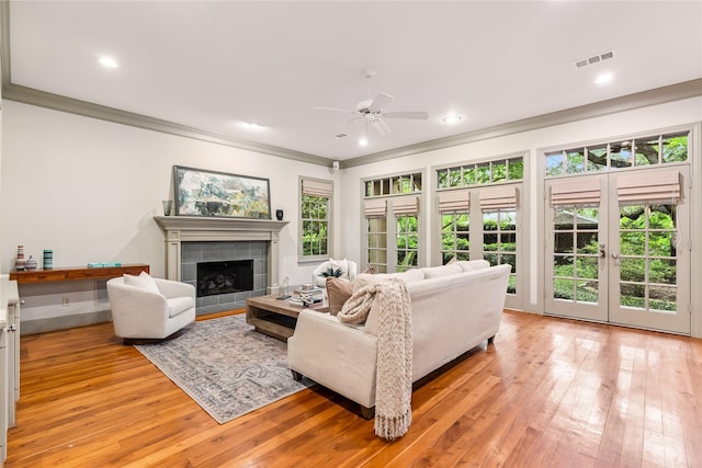 3502 Underwood St, Houston, TX 77025 - living area featuring ornamental molding, ceiling fan, light wood-style flooring, a tile fireplace, and recessed lighting