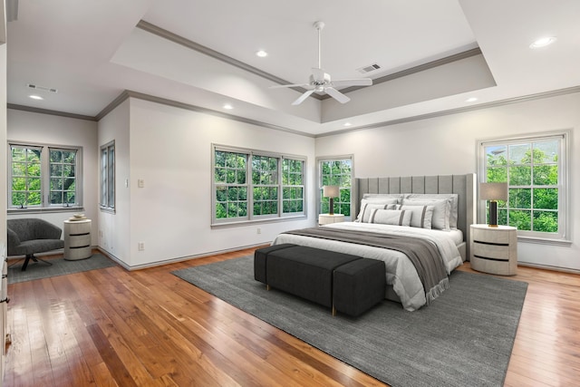3502 Underwood St, Houston, TX 77025 - bedroom featuring crown molding, multiple windows, a raised ceiling, light wood-style floors, and recessed lighting
