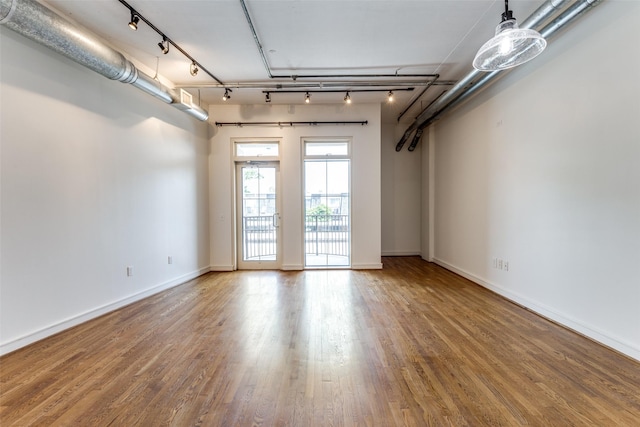 1616 Fountain View Dr Unit 202, Houston, TX 77057 - spare room with wood finished floors, track lighting, and baseboards