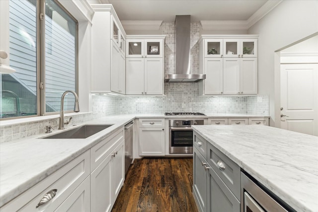 412 W 24th St, Houston, TX 77008 - kitchen with a sink, wall chimney exhaust hood, stainless steel appliances, ornamental molding, and dark wood finished floors