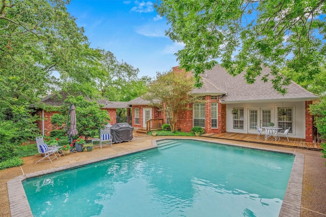 3008 Cochise Ct, College Station, TX 77845 - swimming pool with a deck, french doors, grilling area, and a patio area