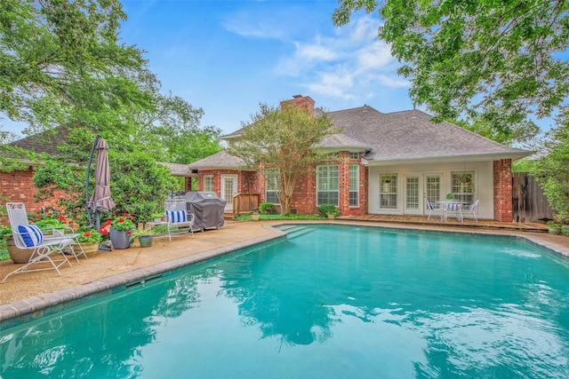 3008 Cochise Ct, College Station, TX 77845 - swimming pool with a patio area, a grill, and french doors