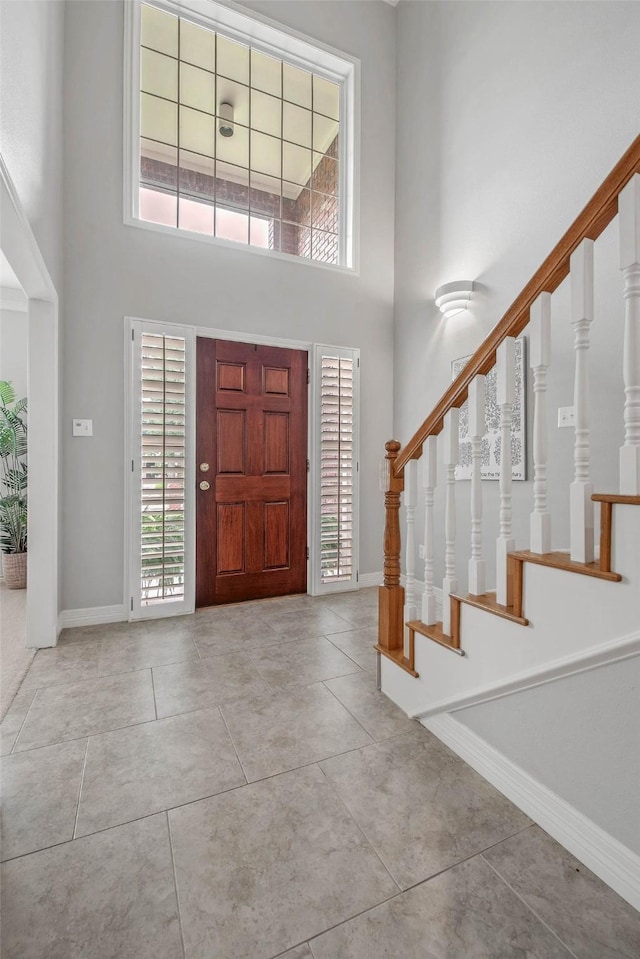 3008 Cochise Ct, College Station, TX 77845 - foyer with a towering ceiling, stairway, baseboards, and tile patterned flooring