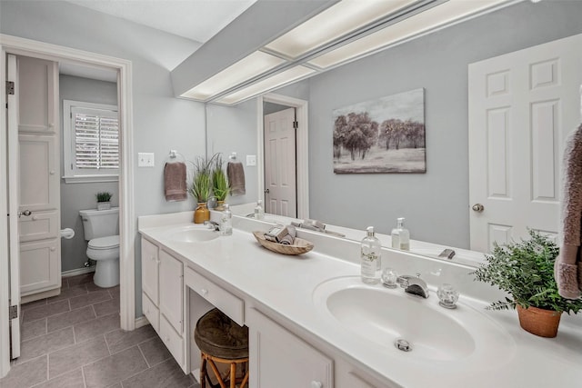 3008 Cochise Ct, College Station, TX 77845 - full bath with toilet, double vanity, tile patterned flooring, and baseboards