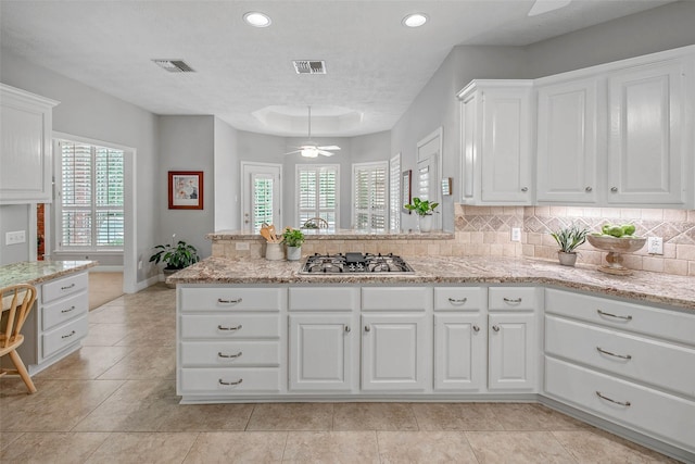 3008 Cochise Ct, College Station, TX 77845 - kitchen featuring stainless steel gas stovetop, white cabinetry, ceiling fan, plenty of natural light, and recessed lighting