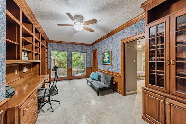 2411 Oakbank Dr, Houston, TX 77339 - office space featuring a ceiling fan, wallpapered walls, light carpet, ornamental molding, and a wainscoted wall