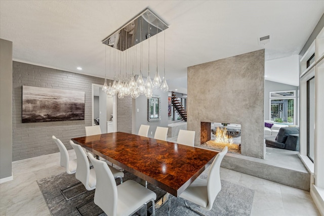 2411 Oakbank Dr, Houston, TX 77339 - dining area featuring a chandelier and brick wall