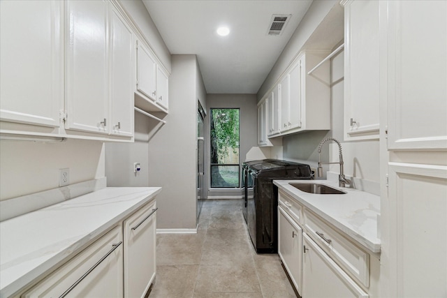2411 Oakbank Dr, Houston, TX 77339 - washroom featuring cabinet space, baseboards, washer and dryer, and recessed lighting