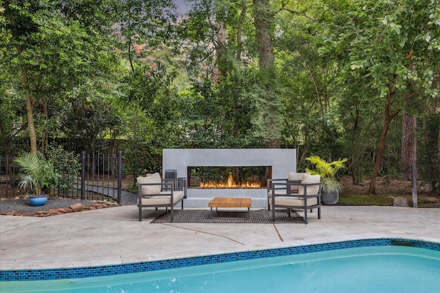 2411 Oakbank Dr, Houston, TX 77339 - outdoor pool with a patio and an outdoor living space with a fireplace